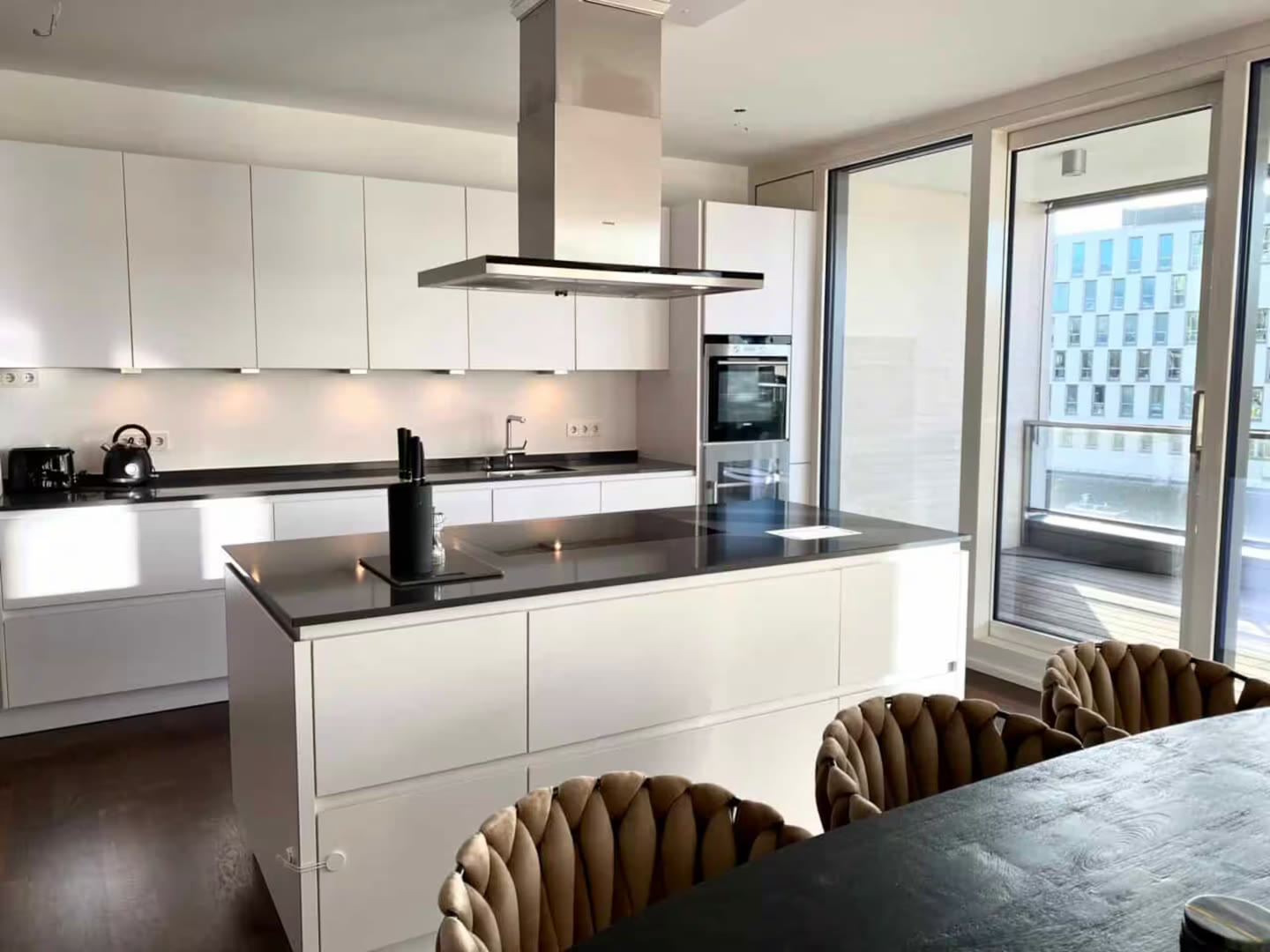 Standard photo of a white kitchen with island